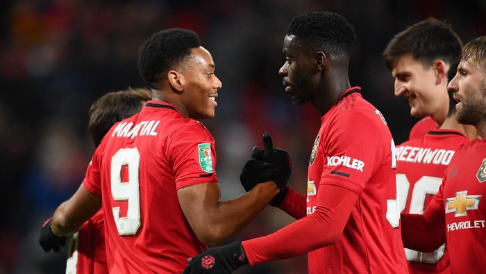 MANCHESTER, ENGLAND - DECEMBER 18: Anthony Martial of Manchester United celebrates with teammates Juan Mata, Eric Bailly, Luke Shaw and Harry Maguire of Manchester United after scoring their teams third goal during the Carabao Cup Quarter Final match between Manchester United and Colchester United at Old Trafford on December 18, 2019 in Manchester, England. (Photo by Clive Mason/Getty Images)