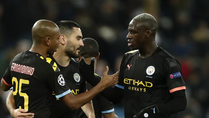 Manchester Citys players celebrate at the end of the Champions League, round of 16, first leg soccer match between Real Madrid and Manchester City at the Santiago Bernabeu stadium in Madrid, Spain, Wednesday, Feb. 26, 2020. (AP Photo/Manu Fernandez)