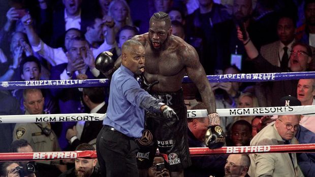 Referee Kenny Bayless directs US boxer Deontay Wilder to his corner after stopping his World Boxing Council (WBC) Heavyweight Championship Title boxing match against British boxer Tyson Fury at the MGM Grand Garden Arena in Las Vegas on February 22, 2020. (Photo by John Gurzinski / AFP)