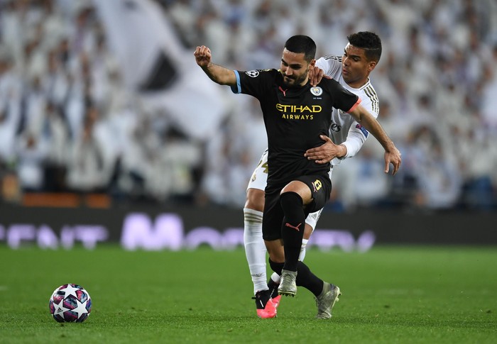 MADRID, SPAIN - FEBRUARY 26: Ilkay Gundogan of Manchester City is challenged by Casemiro of Real Madrid during the UEFA Champions League round of 16 first leg match between Real Madrid and Manchester City at Bernabeu on February 26, 2020 in Madrid, Spain. (Photo by David Ramos/Getty Images)
