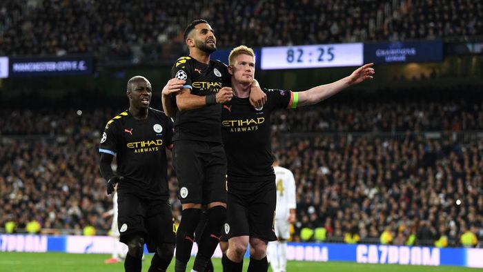 Manchester City MADRID, SPAIN - FEBRUARY 26: Kevin De Bruyne of Manchester City celebrates with teammate Riyad Mahrez after scoring his teams second goal during the UEFA Champions League round of 16 first leg match between Real Madrid and Manchester City at Bernabeu on February 26, 2020 in Madrid, Spain. (Photo by David Ramos/Getty Images)