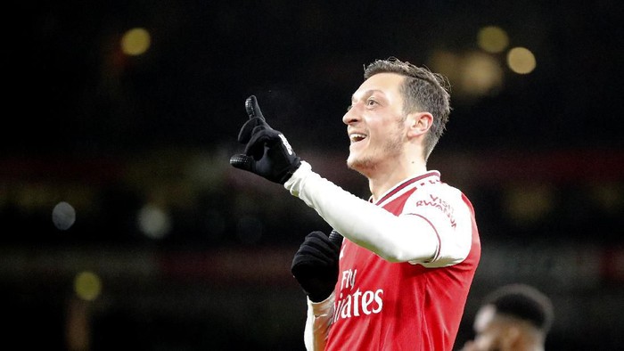 Arsenals Mesut Ozil celebrates after scoring his sides third goal during the English Premier League soccer match between Arsenal and Newcastle at the Emirates Stadium in London, Sunday, Feb. 16, 2020.(AP Photo/Frank Augstein)