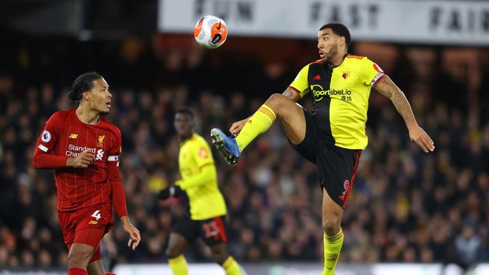 WATFORD, ENGLAND - FEBRUARY 29: Troy Deeney of Watford challenges Virgil van Dijk of Liverpool during the Premier League match between Watford FC and Liverpool FC at Vicarage Road on February 29, 2020 in Watford, United Kingdom. (Photo by Richard Heathcote/Getty Images)