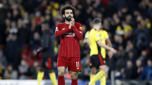 Liverpool's Mohamed Salah applauds to supporters and leaves the field at the end of the English Premier League soccer match between Watford and Liverpool at Vicarage Road stadium, in Watford, England, Saturday, Feb. 29, 2020. The match finished 3-0. (AP Photo/Alastair Grant)