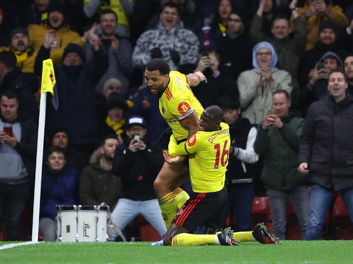 WATFORD, ENGLAND - FEBRUARY 29: Troy Deeney of Watford celebrates after scoring his teams third goal with teammate Abdoulaye Doucoure during the Premier League match between Watford FC and Liverpool FC at Vicarage Road on February 29, 2020 in Watford, United Kingdom. (Photo by Richard Heathcote/Getty Images)