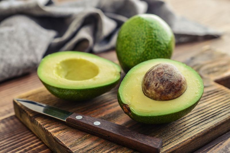 Textured many fresh, organic and green avocado fruits in full-frame background