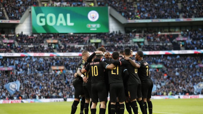 Manchester City players celebrate after Sergio Aguero scored his sides first goal during the League Cup soccer match final between Aston Villa and Manchester City, at Wembley stadium, in London, England, Sunday, March 1, 2020. (AP Photo/Alastair Grant)