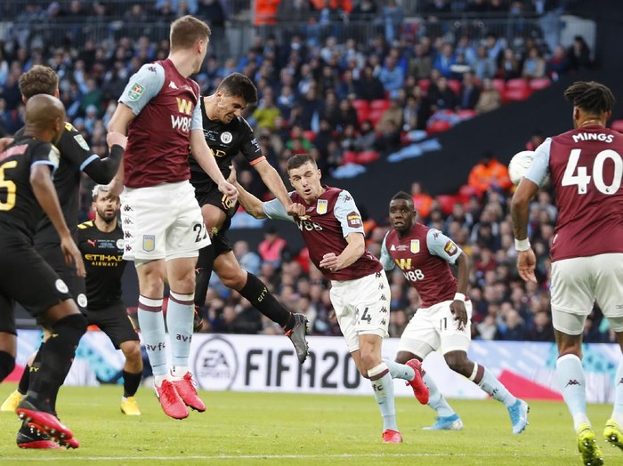 Manchester Citys Rodrigo, left, heads the ball to score his sides second goal during the League Cup soccer match final between Aston Villa and Manchester City, at Wembley stadium, in London, England, Sunday, March 1, 2020. (AP Photo/Alastair Grant)