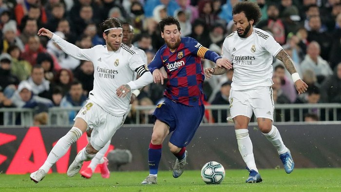 MADRID, SPAIN - MARCH 01: Lionel Messi of FC Barcelona controls the ball while challenged by Sergio Ramos of Real Madrid and Marcelo of Real Madrid during the Liga match between Real Madrid CF and FC Barcelona at Estadio Santiago Bernabeu on March 01, 2020 in Madrid, Spain. (Photo by Gonzalo Arroyo Moreno/Getty Images)