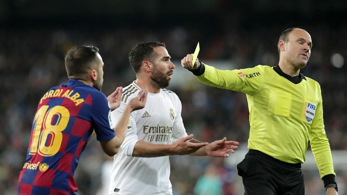 MADRID, SPAIN - MARCH 01: Daniel Carvajal of Real Madrid and Jordi Alba of FC Barcelona are both showed a yellow card by 
referee Antonio Mateu Lahoz during the Liga match between Real Madrid CF and FC Barcelona at Estadio Santiago Bernabeu on March 01, 2020 in Madrid, Spain. (Photo by Gonzalo Arroyo Moreno/Getty Images)