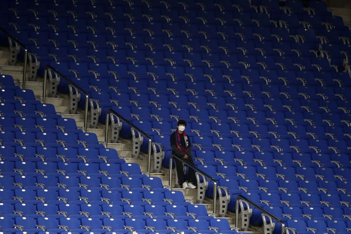 ULSAN, SOUTH KOREA - FEBRUARY 11: A fan in the stands wear a mask in light of novel coronavirus ahead of the AFC Champions League Group F match between Ulsan Hyundai and FC Tokyo at the Ulsan Munsu Football Stadium on February 11, 2020 in Ulsan, South Korea. (Photo by Chung Sung-Jun/Getty Images)