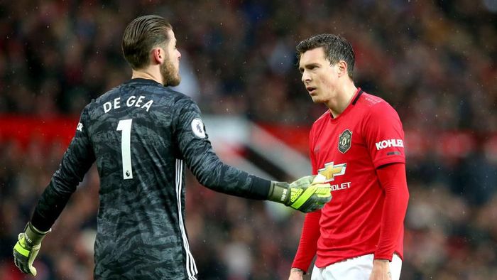 MANCHESTER, ENGLAND - DECEMBER 15: Victor Lindelof of Manchester United reacts with teammate David De Gea after scoring an own goal during the Premier League match between Manchester United and Everton FC at Old Trafford on December 15, 2019 in Manchester, United Kingdom. (Photo by Alex Livesey/Getty Images)