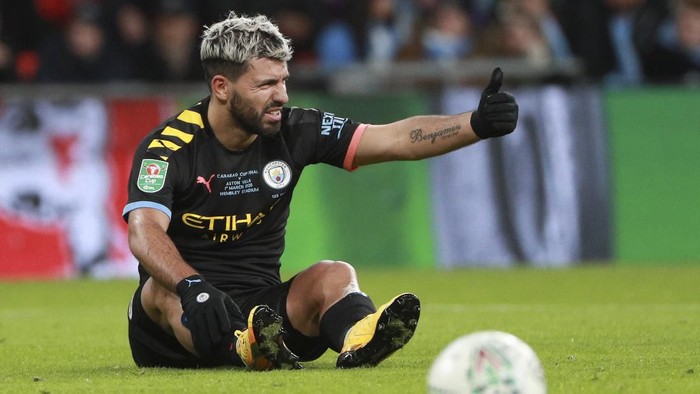Manchester Citys Sergio Aguero sits on the pitch during the League Cup soccer match final between Aston Villa and Manchester City, at Wembley stadium, in London, England, Sunday, March 1, 2020. (AP Photo/Ian Walton)
