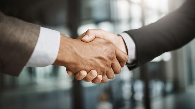 Cropped shot of two unrecognizable businessmen shaking hands in a modern office