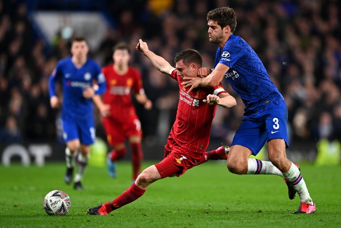 LONDON, ENGLAND - MARCH 03: James Milner of Liverpool is tackled by Marcos Alonso of Chelsea  during the FA Cup Fifth Round match between Chelsea FC and Liverpool FC at Stamford Bridge on March 03, 2020 in London, England. (Photo by Clive Mason/Getty Images)