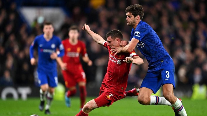 LONDON, ENGLAND - MARCH 03: James Milner of Liverpool is tackled by Marcos Alonso of Chelsea  during the FA Cup Fifth Round match between Chelsea FC and Liverpool FC at Stamford Bridge on March 03, 2020 in London, England. (Photo by Clive Mason/Getty Images)