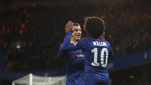 Chelsea's Willian, right, celebrates with Chelsea's Ross Barkley after scoring his side's opening goal during the English FA Cup fifth round soccer match between Chelsea and Liverpool at Stamford Bridge stadium in London Tuesday, March 3, 2020. (AP Photo/Ian Walton)