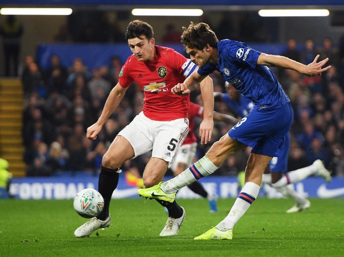 LONDON, ENGLAND - OCTOBER 30: Marcos Alonso of Chelsea shoots under pressure from Harry Maguire of Manchester United during the Carabao Cup Round of 16 match between Chelsea and Manchester United at Stamford Bridge on October 30, 2019 in London, England. (Photo by Mike Hewitt/Getty Images)