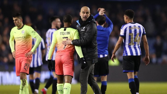 SHEFFIELD, ENGLAND - MARCH 04: Pep Guardiola, Manager of Manchester City celebrates with Raheem Sterling of Manchester City following their victory in the FA Cup Fifth Round match between Sheffield Wednesday and Manchester City at Hillsborough on March 04, 2020 in Sheffield, England. (Photo by Alex Livesey/Getty Images)