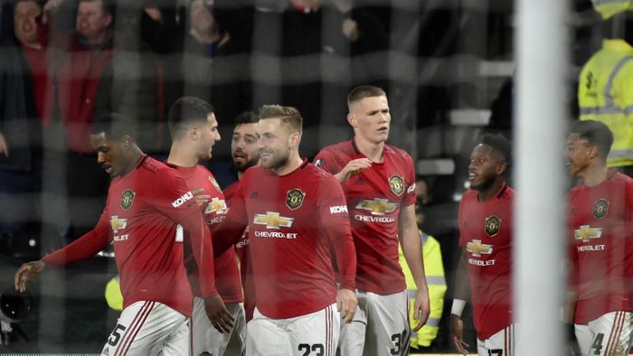 Manchester Uniteds Luke Shaw, front, celebrates with teammates after scoring his sides opening goal during the FA Cup fifth round soccer match between Derby County and Manchester United at Pride Park in Derby, England, Thursday, March 5, 2020. (AP Photo/Rui Vieira)