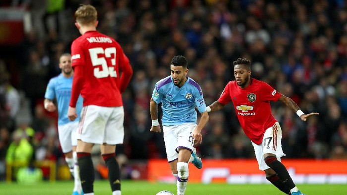 MANCHESTER, ENGLAND - JANUARY 07: Riyad Mahrez of Manchester City takes the ball past Fred of Manchester United during the Carabao Cup Semi Final match between Manchester United and Manchester City at Old Trafford on January 07, 2020 in Manchester, England. (Photo by Michael Steele/Getty Images)