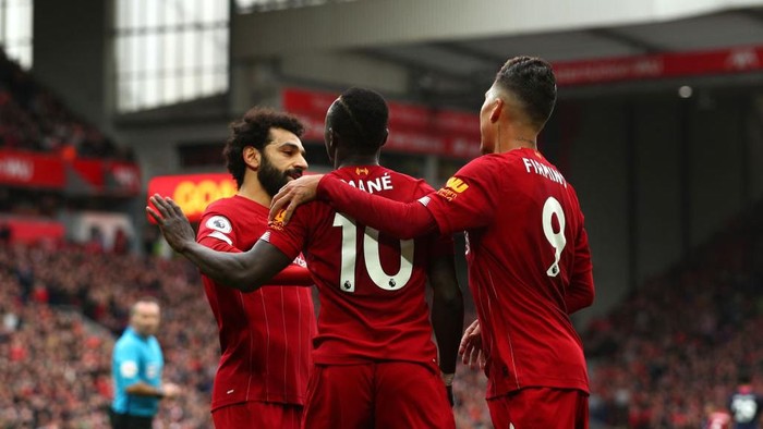 LIVERPOOL, ENGLAND - MARCH 07: Sadio Mane of Liverpool celebrates with Mohamed Salah and Roberto Firmino after scoring his teams second goal during the Premier League match between Liverpool FC and AFC Bournemouth  at Anfield on March 07, 2020 in Liverpool, United Kingdom. (Photo by Jan Kruger/Getty Images)