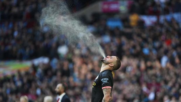 Manchester City's Kyle Walker sprays liquid in the air prior to the League Cup soccer match final between Aston Villa and Manchester City, at Wembley stadium, in London, England, Sunday, March 1, 2020. (AP Photo/Ian Walton)
