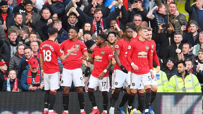 MANCHESTER, ENGLAND - MARCH 08: Anthony Martial of Manchester United celebrates with his team after scoring his sides first goal during the Premier League match between Manchester United and Manchester City at Old Trafford on March 08, 2020 in Manchester, United Kingdom. (Photo by Laurence Griffiths/Getty Images)