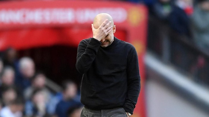MANCHESTER, ENGLAND - MARCH 08: Pep Guardiola, Manager of Manchester City holds his head in his hands during the Premier League match between Manchester United and Manchester City at Old Trafford on March 08, 2020 in Manchester, United Kingdom. (Photo by Michael Regan/Getty Images)