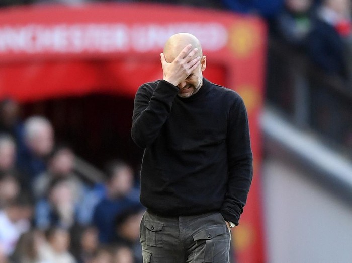 MANCHESTER, ENGLAND - MARCH 08: Pep Guardiola, Manager of Manchester City holds his head in his hands during the Premier League match between Manchester United and Manchester City at Old Trafford on March 08, 2020 in Manchester, United Kingdom. (Photo by Michael Regan/Getty Images)