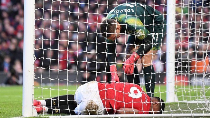 MANCHESTER, ENGLAND - MARCH 08: Anthony Martial of Manchester United is injured after Ederson of Manchester City clears the ball and collides with Anthony Martial of Manchester United  during the Premier League match between Manchester United and Manchester City at Old Trafford on March 08, 2020 in Manchester, United Kingdom. (Photo by Laurence Griffiths/Getty Images)