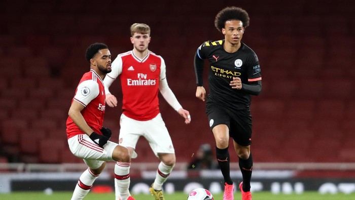 LONDON, ENGLAND - FEBRUARY 28: Leroy Sane of Manchester City runs with the ball under pressure from Trae Coyle of Arsenal during the Premier League 2 match between Arsenal U23 and Manchester City U23 at Emirates Stadium on February 28, 2020 in London, England. (Photo by Linnea Rheborg/Getty Images)