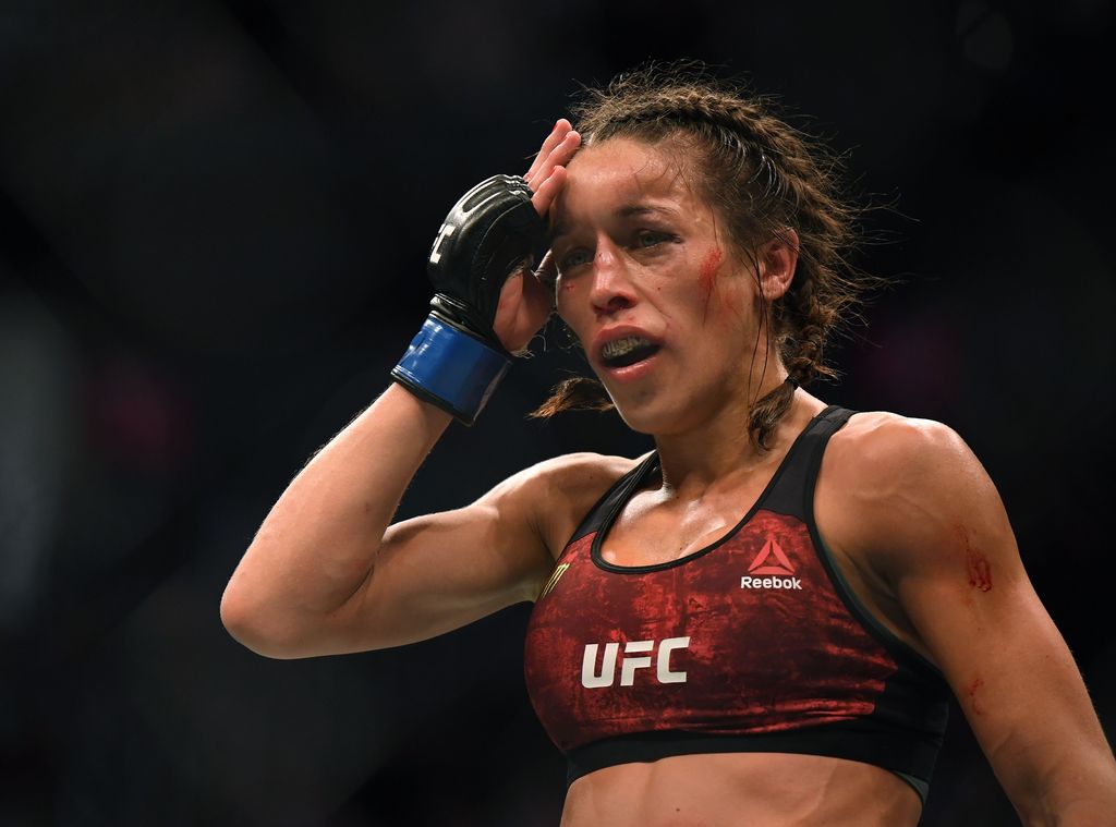 LAS VEGAS, NEVADA - MARCH 07:  Joanna Jedrzejczyk punches Weili Zhang in a split decision loss during a strawweight title bout at T-Mobile Arena on March 07, 2020 in Las Vegas, Nevada. (Photo by Harry How/Getty Images)