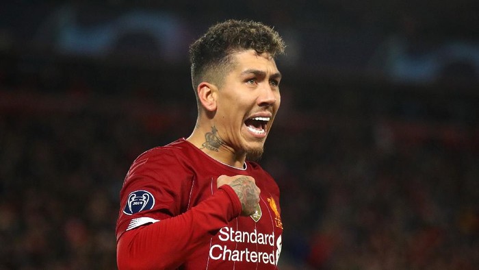 LIVERPOOL, ENGLAND - MARCH 11: Roberto Firmino of Liverpool celebrates after scoring his teams second goal during the UEFA Champions League round of 16 second leg match between Liverpool FC and Atletico Madrid at Anfield on March 11, 2020 in Liverpool, United Kingdom.  (Photo by Julian Finney/Getty Images)
