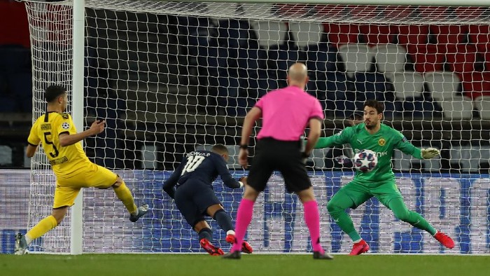 PARIS, FRANCE - MARCH 11: (FREE FOR EDITORIAL USE) In this handout image provided by UEFA, Neymar of Paris Saint-Germain scores his teams first goal past Roman Buerki of Borussia Dortmund during the UEFA Champions League round of 16 second leg match between Paris Saint-Germain and Borussia Dortmund at Parc des Princes on March 11, 2020 in Paris, France. The match is played behind closed doors as a precaution against the spread of COVID-19 (Coronavirus).  (Photo by UEFA - Handout/UEFA via Getty Images)