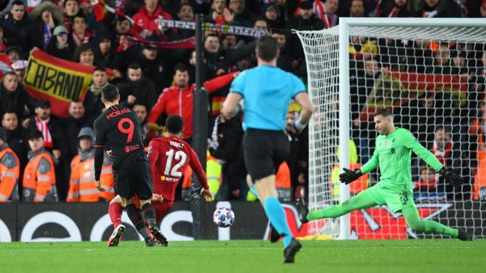 LIVERPOOL, ENGLAND - MARCH 11: Alvaro Morata of Atletico Madrid scores his teams third goal past Adrian of Liverpool during the UEFA Champions League round of 16 second leg match between Liverpool FC and Atletico Madrid at Anfield on March 11, 2020 in Liverpool, United Kingdom.  (Photo by Laurence Griffiths/Getty Images)
