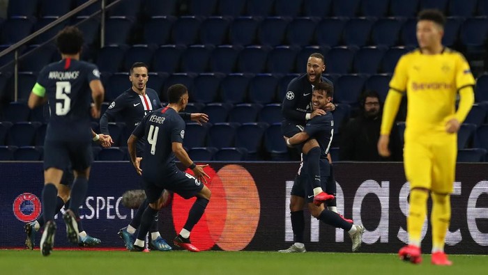 PARIS, FRANCE - MARCH 11: (FREE FOR EDITORIAL USE) In this handout image provided by UEFA, Juan Bernat of Paris Saint-Germain celebrates with Neymar after scoring his teams second goal during the UEFA Champions League round of 16 second leg match between Paris Saint-Germain and Borussia Dortmund at Parc des Princes on March 11, 2020 in Paris, France. The match is played behind closed doors as a precaution against the spread of COVID-19 (Coronavirus).  (Photo by UEFA - Handout/UEFA via Getty Images)