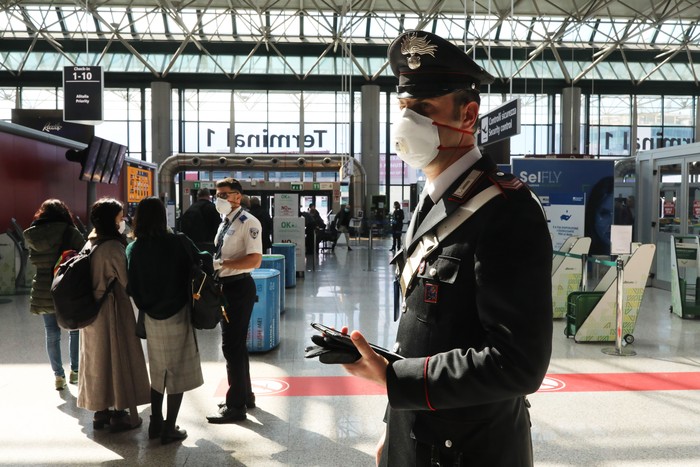 ROME, ITALY - MARCH 12: A Carabinieri Paramilitary Police Officer wearing a protective mask at the Fiumicino airport on March 12, 2020 in Rome, Italy. United States President Donald Trump imposed a 30-day ban on travel from nearly all European countries, beginning tomorrow. The action was condemned by the E.U.s top officials saying:  that the decision was taken unilaterally and without consultation. (Photo by Marco Di Lauro/Getty Images)