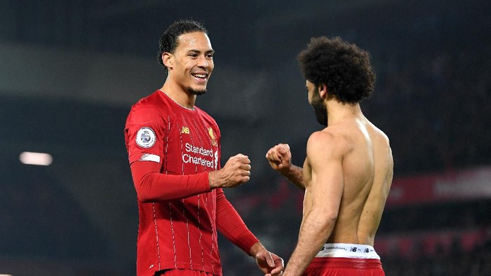 LIVERPOOL, ENGLAND - JANUARY 19: Virgil van Dijk and Mohamed Salah of Liverpool celebrate victory after the Premier League match between Liverpool FC and Manchester United at Anfield on January 19, 2020 in Liverpool, United Kingdom. (Photo by Michael Regan/Getty Images)