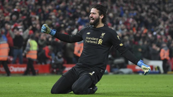 LIVERPOOL, ENGLAND - JANUARY 19: Alisson Becker of Liverpool celebrates the 2nd goal during the Premier League match between Liverpool FC and Manchester United at Anfield on January 19, 2020 in Liverpool, United Kingdom. (Photo by Michael Regan/Getty Images)
