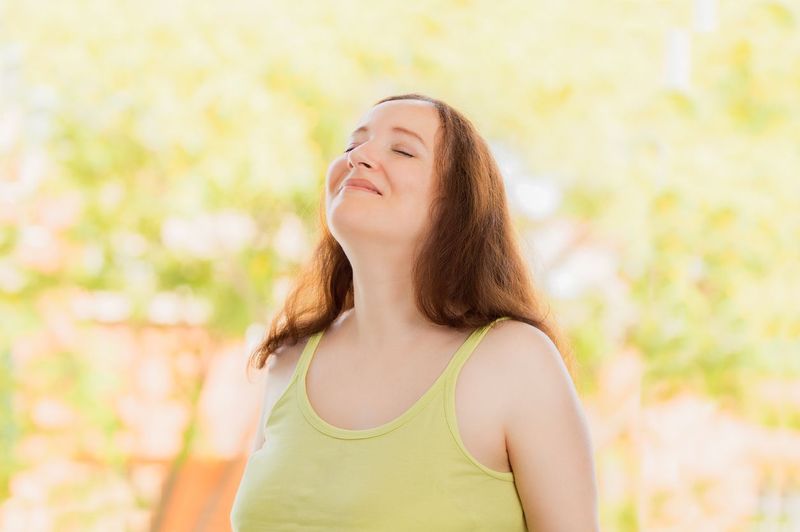 Profile of a couple of man and woman breathing deep fresh air together at sunset