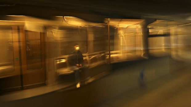 A man wearing a face mask travels in a virtually empty metro in Brussels, Thursday, March 19, 2020. Belgium has ordered further lockdown measures following in the steps of European neighbors Italy, Spain and France. For most people, the new coronavirus causes only mild or moderate symptoms, such as fever and cough. For some, especially older adults and people with existing health problems, it can cause more severe illness, including pneumonia. (AP Photo/Francisco Seco)