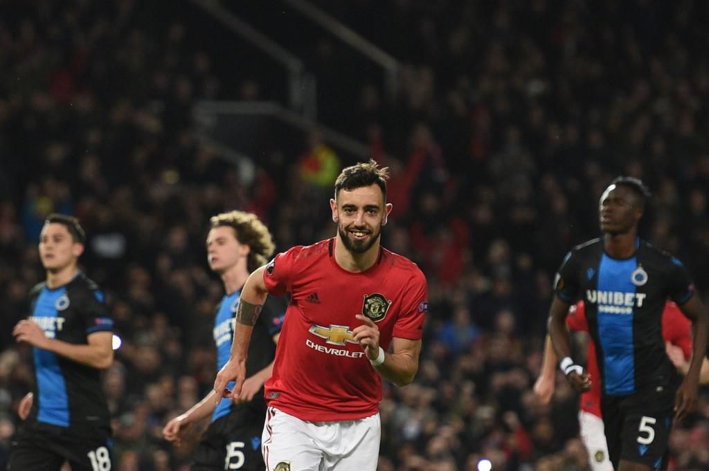 Manchester United's Portuguese midfielder Bruno Fernandes celebrates scoring his team's first goal during the UEFA Europa League round of 32 second leg football match between Manchester United and Club Brugge at Old Trafford in Manchester, north west England, on February 27, 2020. (Photo by Oli SCARFF / AFP)
