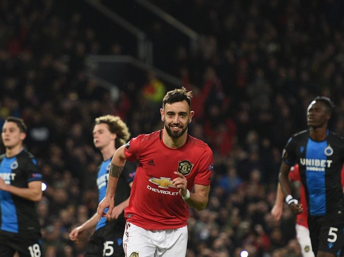 Manchester Uniteds Portuguese midfielder Bruno Fernandes celebrates scoring his teams first goal during the UEFA Europa League round of 32 second leg football match between Manchester United and Club Brugge at Old Trafford in Manchester, north west England, on February 27, 2020. (Photo by Oli SCARFF / AFP)