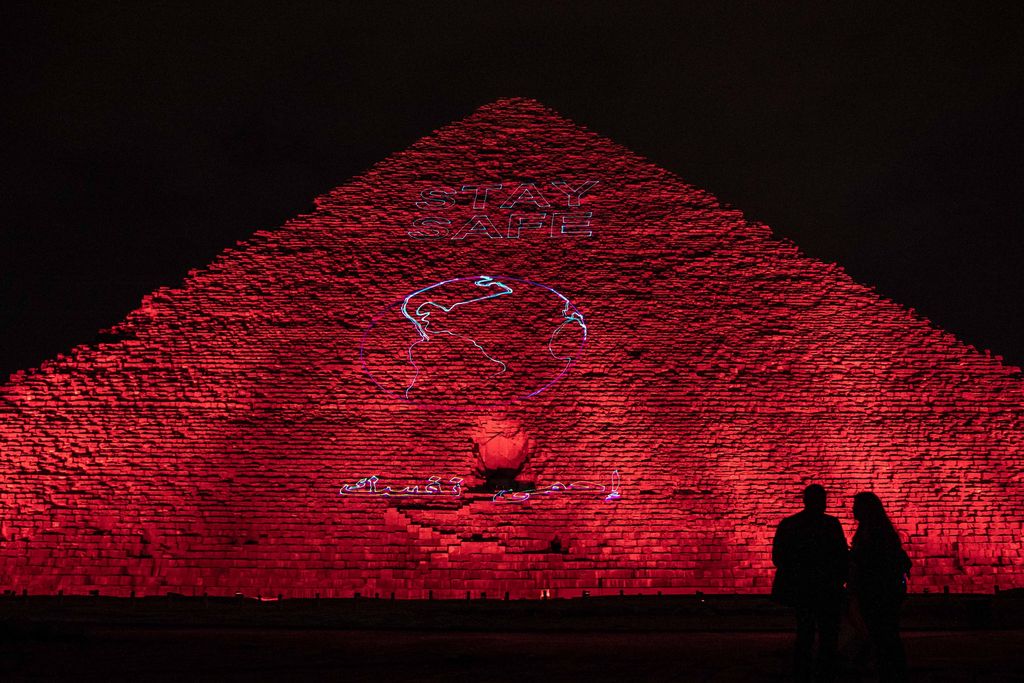 The Ministry of antiquities lights up the pyramids in an expression of support for health workers battling the coronavirus outbreak, Monday, March 30, 2020, in Giza, Egypt. (AP Photo/Nariman El-Mofty)