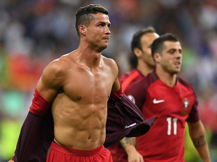 PARIS, FRANCE - JULY 10:  Cristiano Ronaldo of Portugal takes off his shirt to celebrate winning at the final whistle after the UEFA EURO 2016 Final match between Portugal and France at Stade de France on July 10, 2016 in Paris, France.  (Photo by Mike Hewitt/Getty Images)