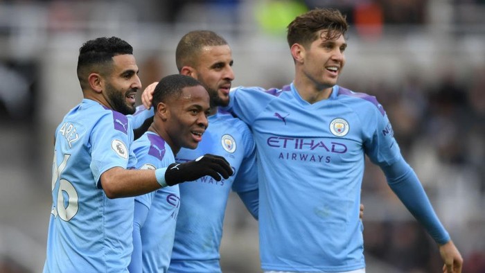 NEWCASTLE UPON TYNE, ENGLAND - NOVEMBER 30: Raheem Sterling of Manchester City celebrates with teammates Riyad Mahrez, Kyle Walker and John Stones after scoring his teams first goal during the Premier League match between Newcastle United and Manchester City at St. James Park on November 30, 2019 in Newcastle upon Tyne, United Kingdom. (Photo by Stu Forster/Getty Images)