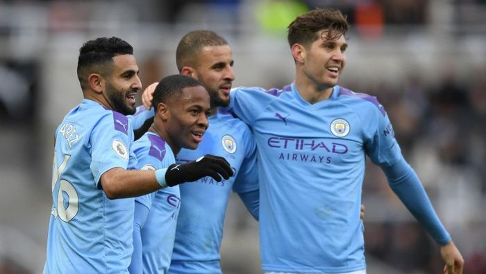 Kyle Walker, Manchester City NEWCASTLE UPON TYNE, ENGLAND - NOVEMBER 30: Raheem Sterling of Manchester City celebrates with teammates Riyad Mahrez, Kyle Walker and John Stones after scoring his teams first goal during the Premier League match between Newcastle United and Manchester City at St. James Park on November 30, 2019 in Newcastle upon Tyne, United Kingdom. (Photo by Stu Forster/Getty Images)