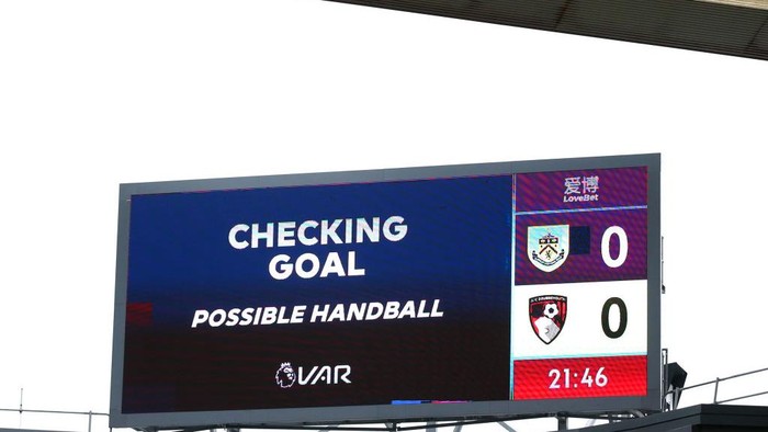 BURNLEY, ENGLAND - FEBRUARY 22: The LED screen shows the VAR check taking place, which later rules out AFC Bournemouths first goal for a handball during the Premier League match between Burnley FC and AFC Bournemouth  at Turf Moor on February 22, 2020 in Burnley, United Kingdom. (Photo by Alex Livesey/Getty Images)