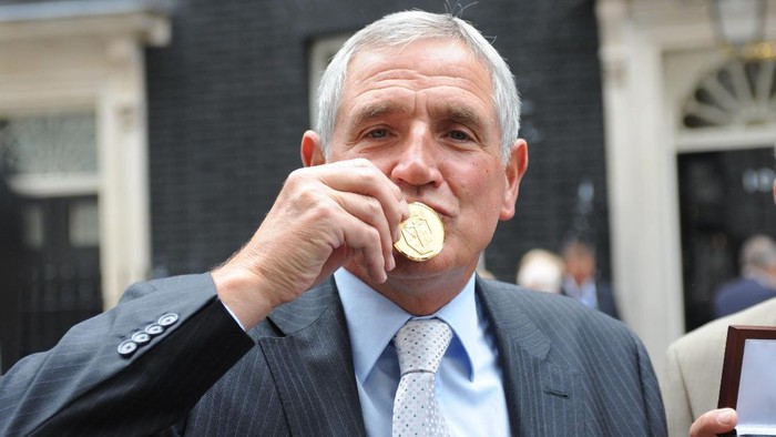 LONDON, UNITED KINGDOM - JUNE 10: Norman Hunter kisses his medal, presented by Prime Minister Gordon Brown for representing his country in the 1966 World Cup  on June 10, 2009 in London England. When England lifted the World Cup it was customary that only the 11 players on the pitch at the final whistle were awarded medals. Today, Prime Minister Gordon Brown handed out medals to the other players and families of the backroom staff. (Photo by Ian Nicholson/WPA Pool/Getty Images)